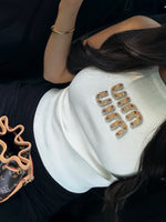TOP BLANC COTELÉ AVEC LOGO BRODÉ DORÉ