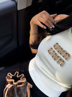 TOP BLANC COTELÉ AVEC LOGO BRODÉ DORÉ